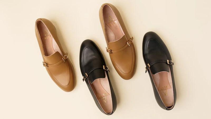 Top-down view of ALLY City Loafers in black and camel leather, featuring almond toes, adjustable buckle details, and a timeless design for polished everyday workwear.