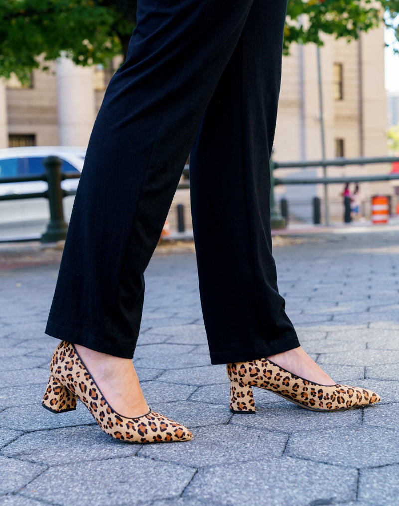Person wearing leopard print shoes on a city street