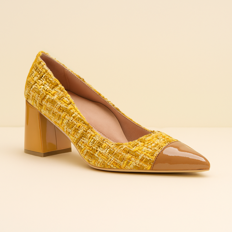 Yellow textured shoe with brown heel and toe on a beige background